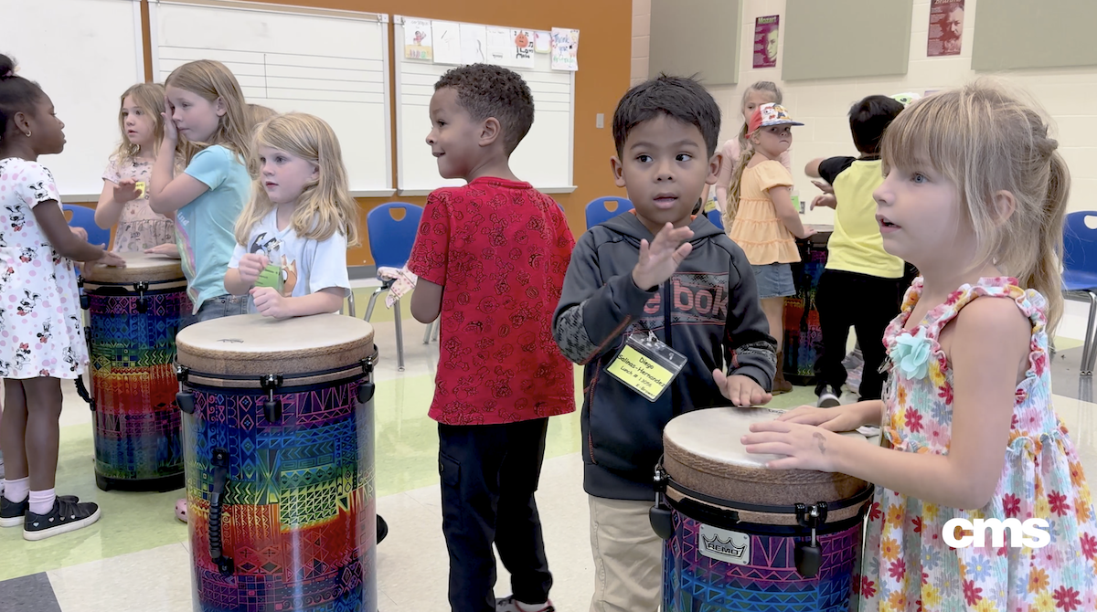  First graders playing drums in music class